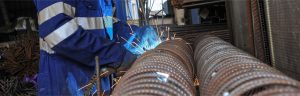 Devoran Metals employee works on cut and bent steel reinforcement bars from the workshop in Cornwall.