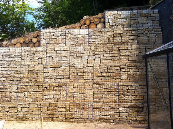 Large gabion wall retaining a crumbling embankment in Hobscheid, Luxembourg.