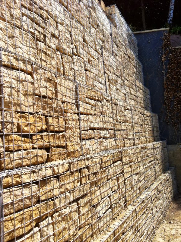 Gabion wall that has been stepped at each course to improve stability.