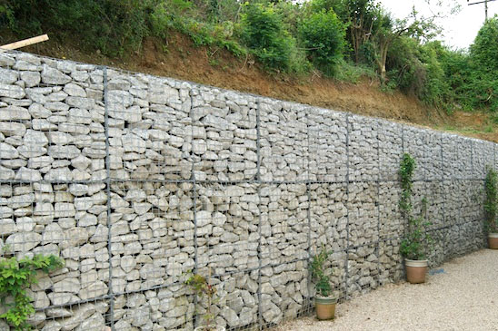 Tall walled embankment to side of driveway in Cornwall using 1m gabion cages filled with granite